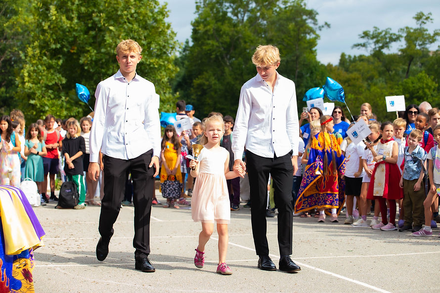 Russian School Erudite students and families during an outdoor school ceremony